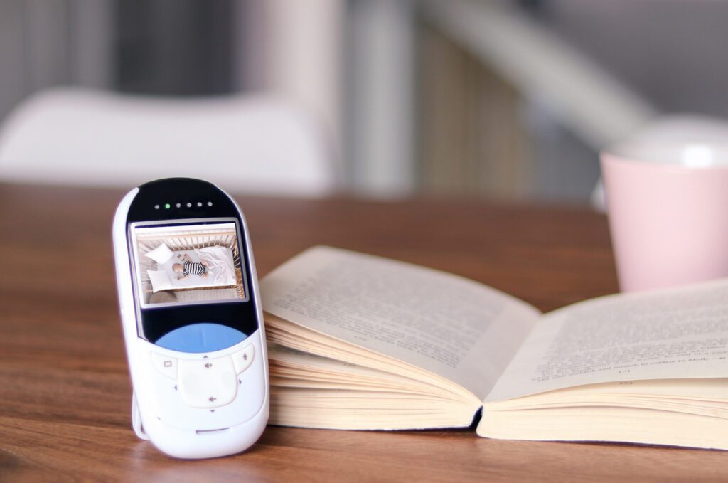 Photo of a baby monitor and a book.
